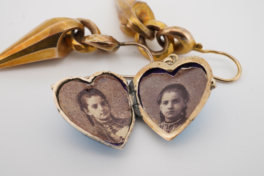 A pair of Victorian yellow metal drop earrings, 32mm excluding ear wire, together with a blue enamel and seed pearl set heart shaped locket(chip). Condition - poor